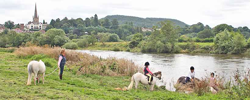 Gravel beach with Ross on Wye in the background